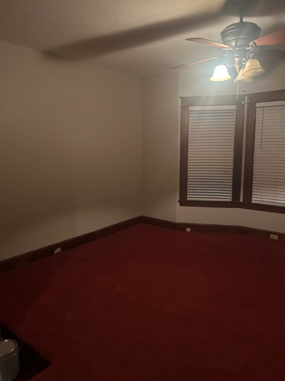 carpeted empty room featuring ceiling fan