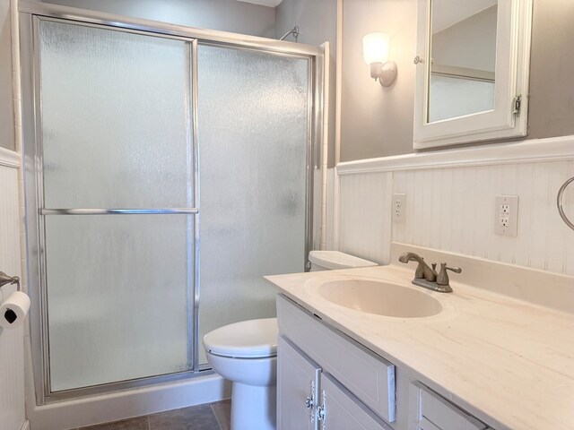 bathroom with an enclosed shower, vanity, and toilet