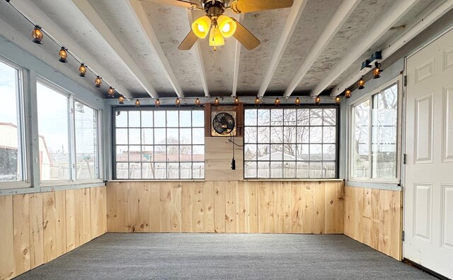 unfurnished sunroom with plenty of natural light and ceiling fan