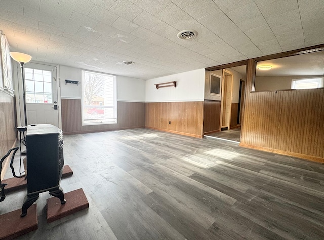 interior space featuring dark hardwood / wood-style floors and wood walls