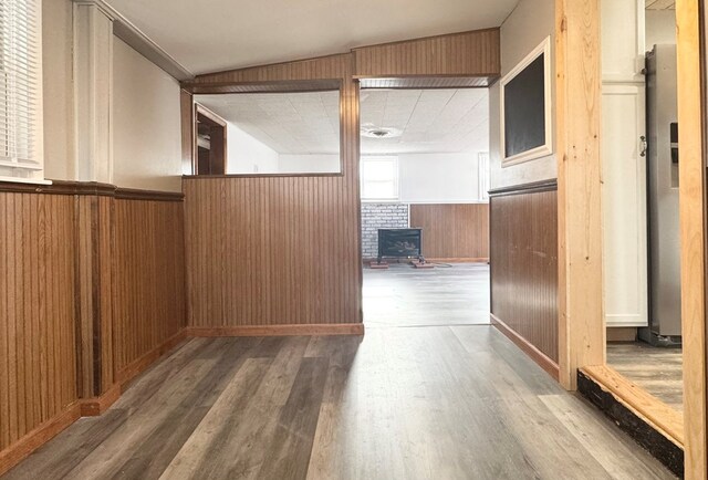 hall with hardwood / wood-style floors and wood walls