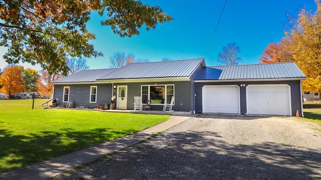 ranch-style home with a garage, a front yard, and covered porch