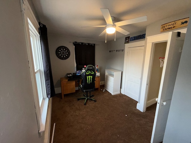 office area with ceiling fan and dark carpet