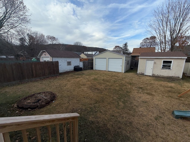 view of yard featuring a garage and a storage unit