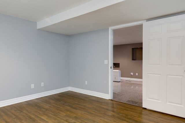 unfurnished room featuring dark wood-type flooring