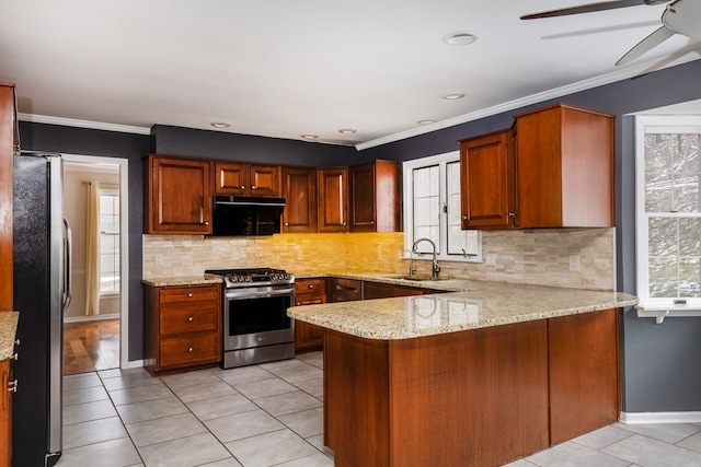 kitchen featuring sink, ornamental molding, kitchen peninsula, and appliances with stainless steel finishes