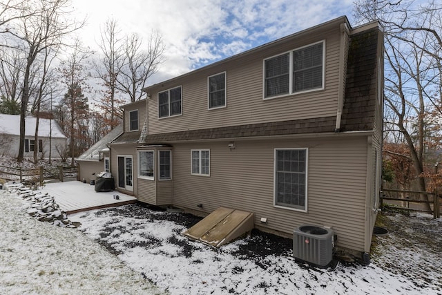 snow covered property featuring cooling unit