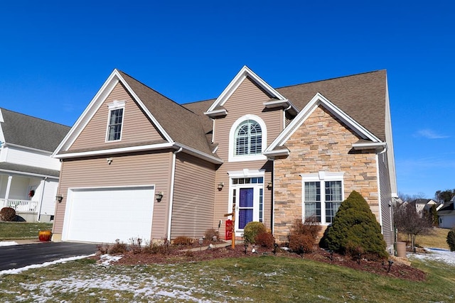 view of front property featuring a garage and a front lawn