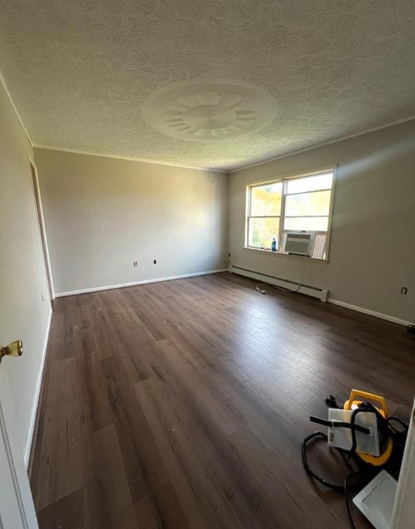 unfurnished room with dark wood-type flooring, a textured ceiling, and baseboard heating