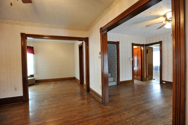 hall with radiator, a textured ceiling, and dark hardwood / wood-style floors