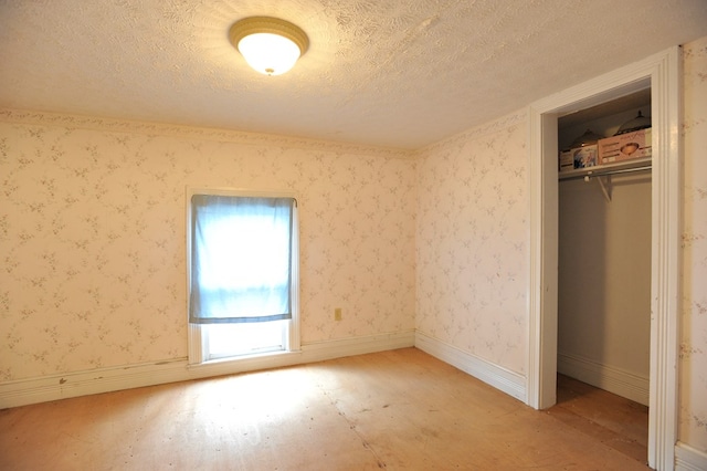 unfurnished bedroom featuring a closet and a textured ceiling