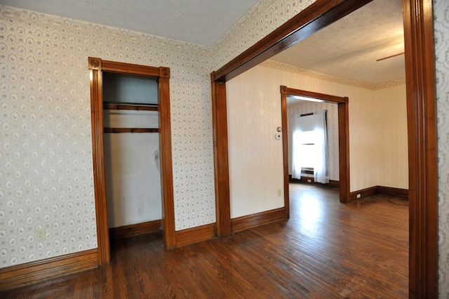 unfurnished bedroom with dark wood-type flooring, a closet, and a textured ceiling