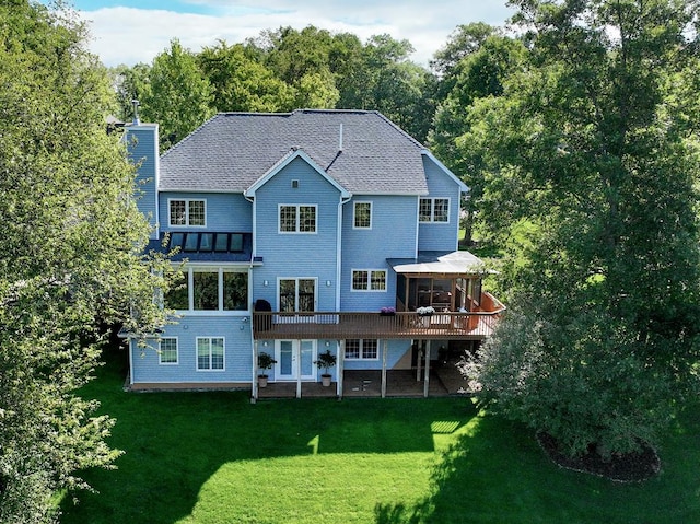 back of house with a wooden deck, a gazebo, and a lawn