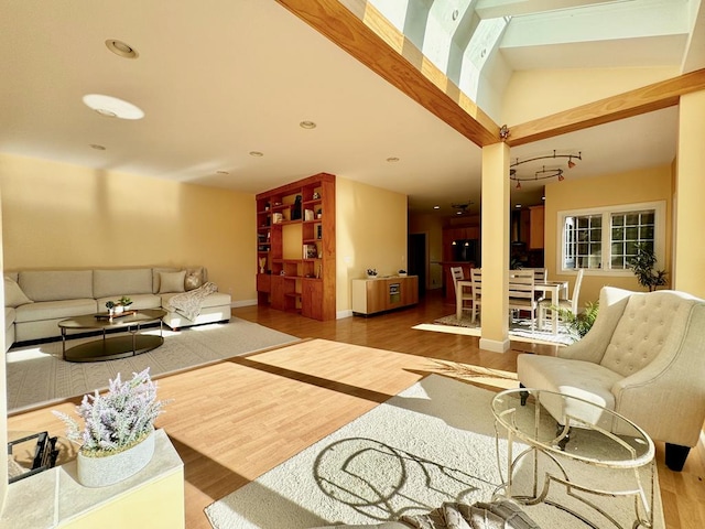 living room with hardwood / wood-style floors and vaulted ceiling