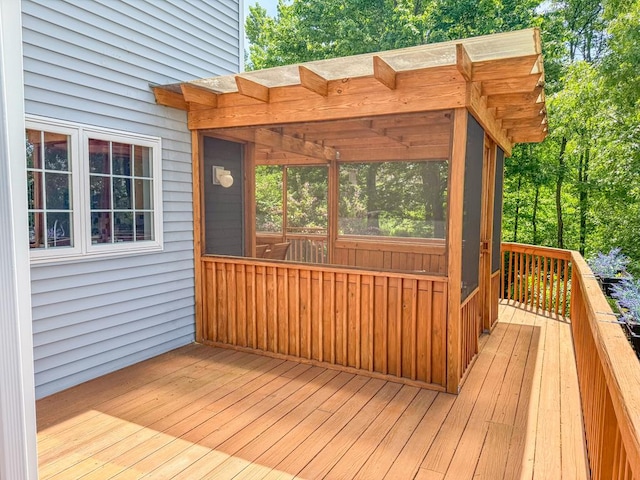 wooden deck featuring a sunroom