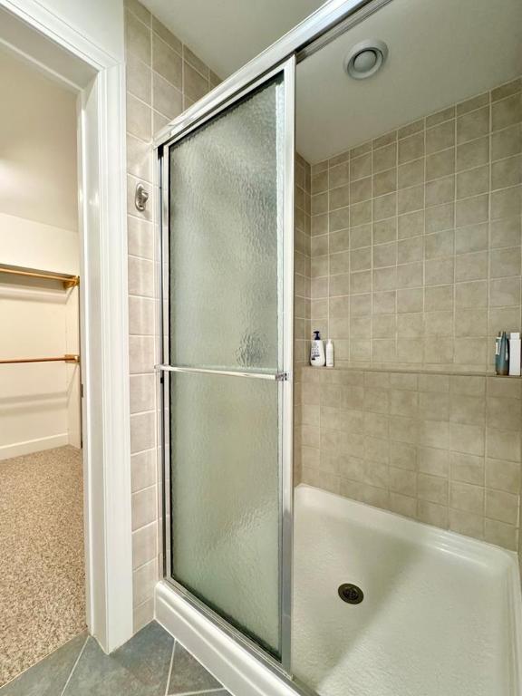 bathroom featuring tile patterned floors and a shower with door