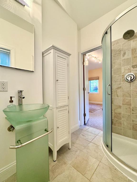 bathroom featuring tile patterned floors, sink, and a shower with door