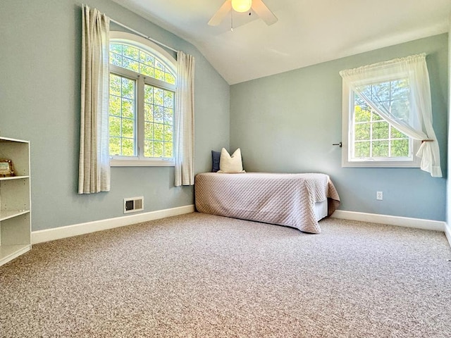 carpeted bedroom featuring ceiling fan and lofted ceiling