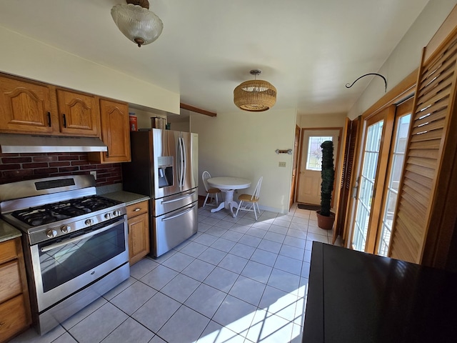 kitchen featuring light tile patterned flooring, appliances with stainless steel finishes, and backsplash