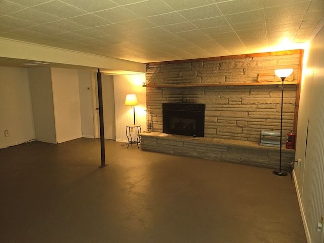 basement with a stone fireplace