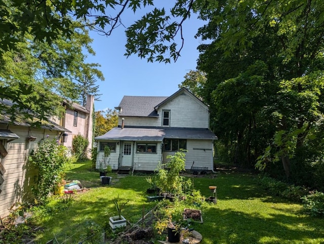 back of property featuring a lawn