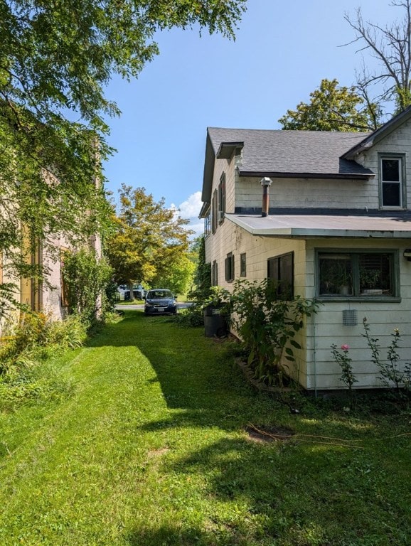 view of property exterior with a lawn