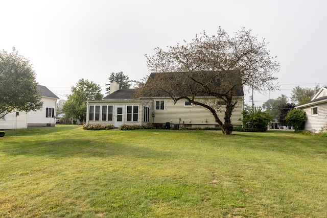 rear view of house with a lawn
