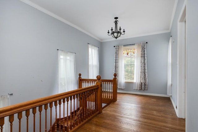 interior space featuring an inviting chandelier, ornamental molding, and dark hardwood / wood-style floors