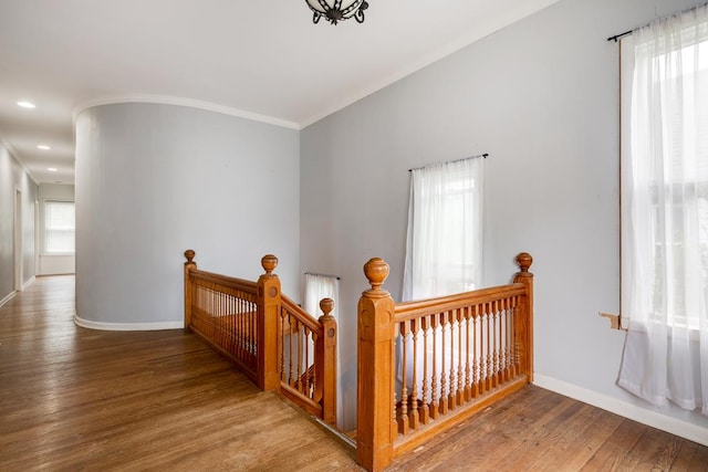 hall with hardwood / wood-style flooring and ornamental molding