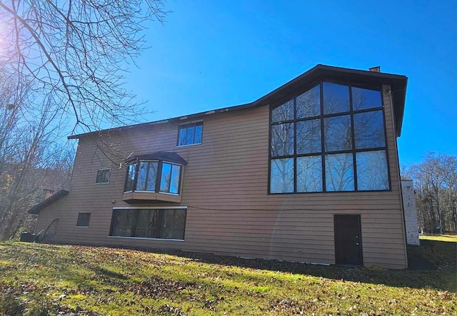 rear view of property featuring a yard