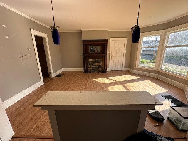 unfurnished dining area featuring ornamental molding and light wood-type flooring