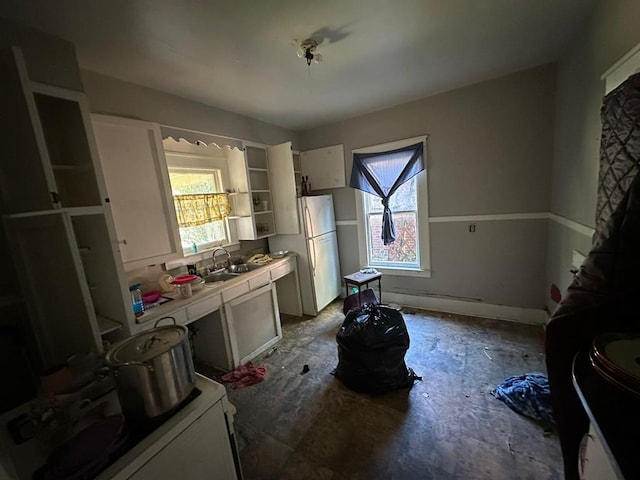 kitchen featuring white fridge and sink