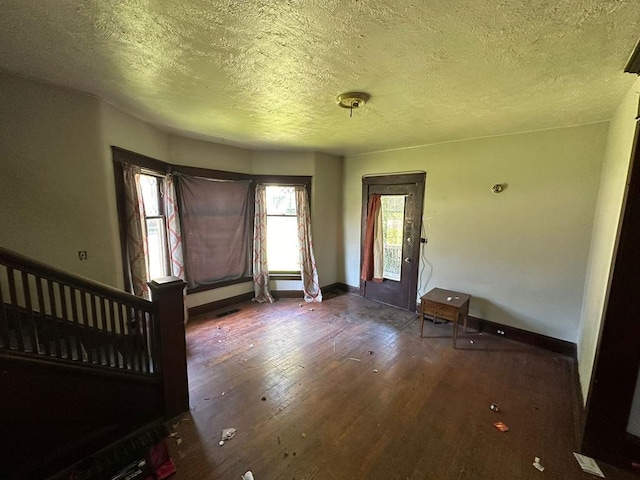 entryway with hardwood / wood-style flooring and a textured ceiling