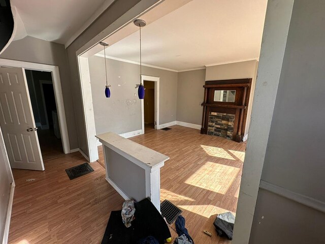 interior space with wood-type flooring and crown molding