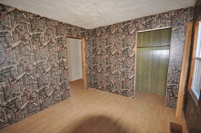 interior space with wood-type flooring and a textured ceiling