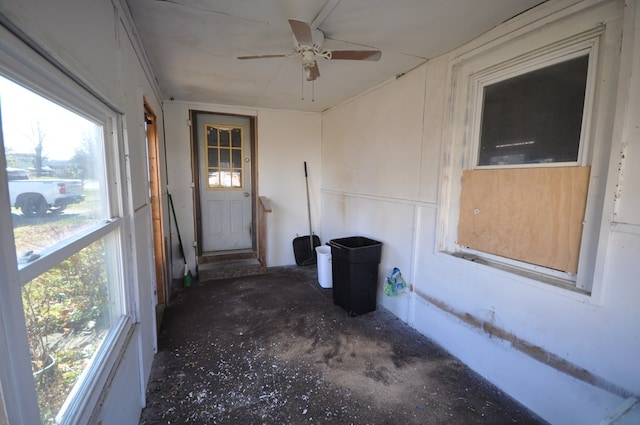 unfurnished sunroom featuring ceiling fan