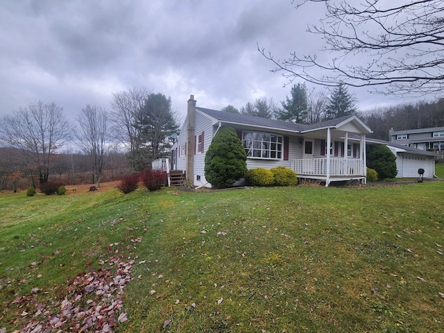 view of side of home featuring a porch and a yard