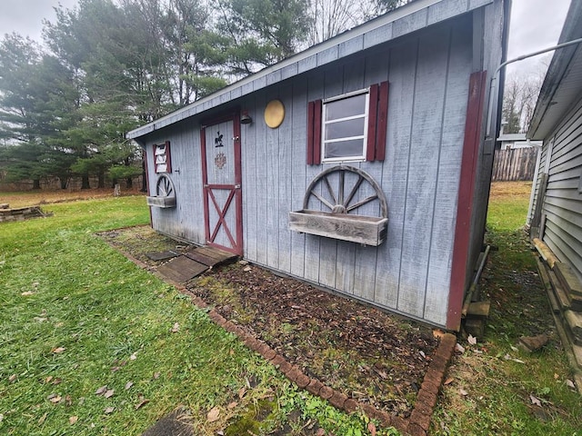 view of outbuilding with a yard