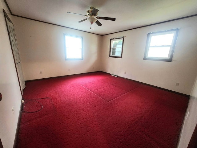 unfurnished room featuring crown molding, carpet flooring, and ceiling fan