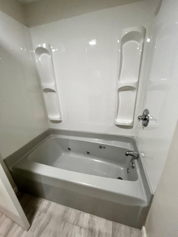 bathroom featuring hardwood / wood-style flooring and tub / shower combination