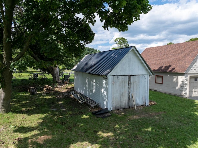 view of outdoor structure featuring a lawn