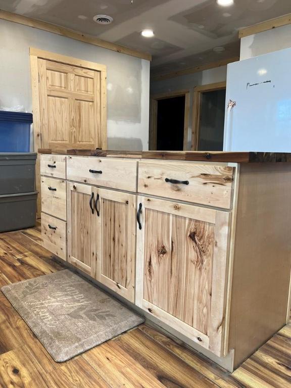 kitchen with hardwood / wood-style flooring and light brown cabinets