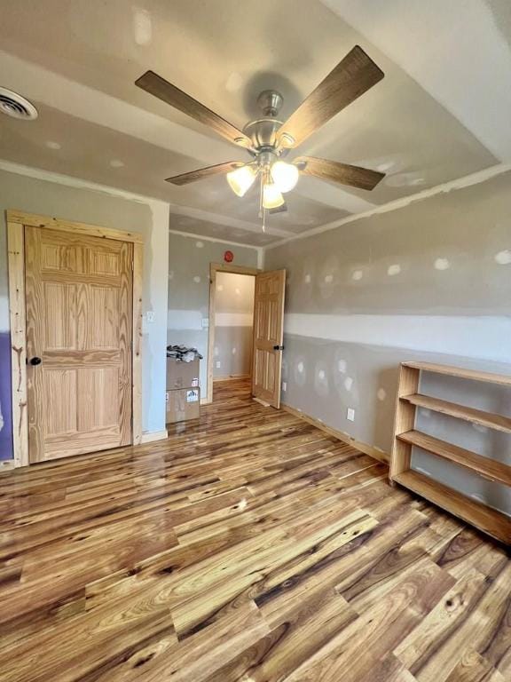 unfurnished bedroom featuring ceiling fan and hardwood / wood-style floors