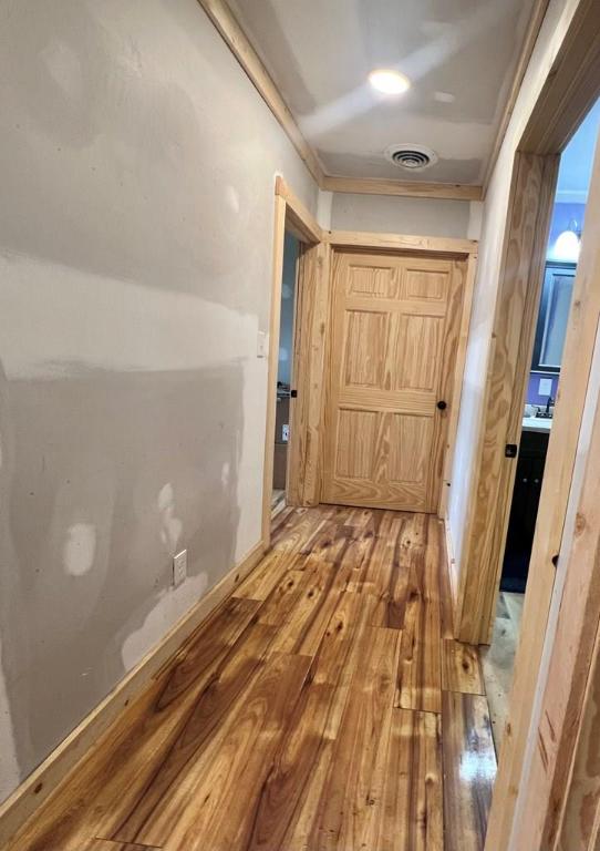 hallway with wood-type flooring