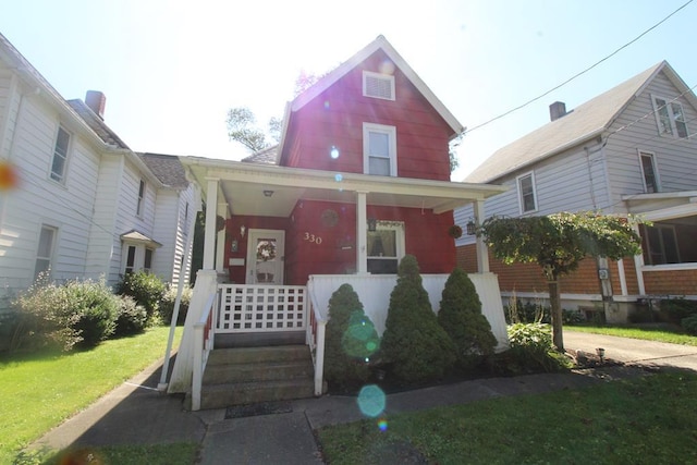 view of front facade featuring a front yard and a porch