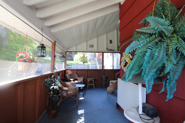 sunroom / solarium with lofted ceiling with beams