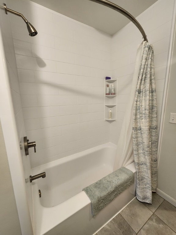 bathroom with tile patterned floors and shower / bath combo with shower curtain