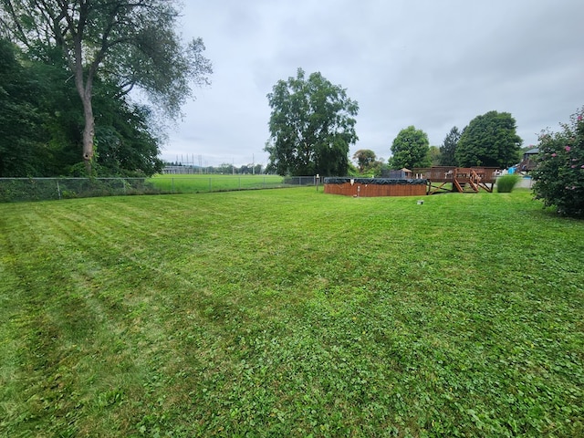 view of yard with a fenced in pool and a playground