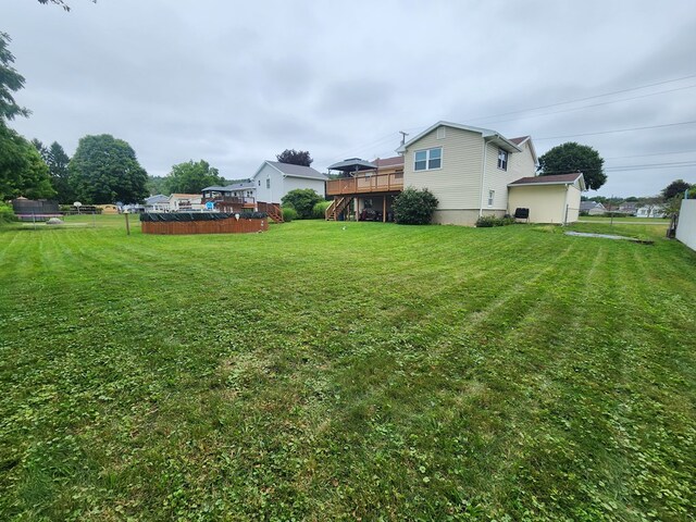 view of yard with fence and a wooden deck