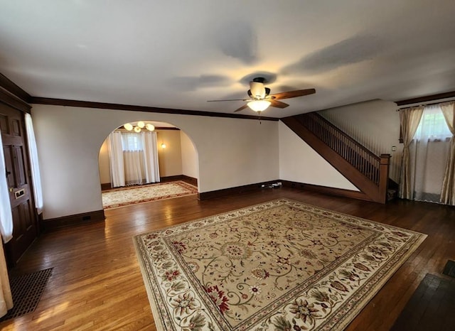 interior space with dark wood-type flooring and ceiling fan